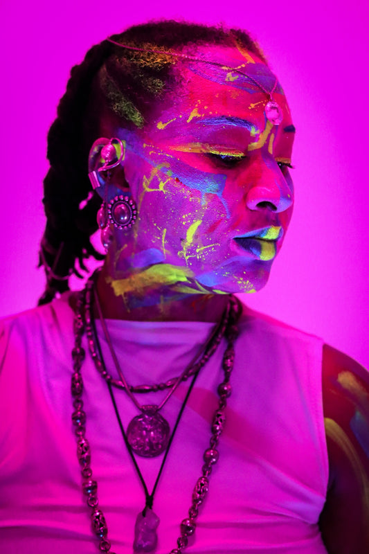 Woman with neon face paint and necklaces